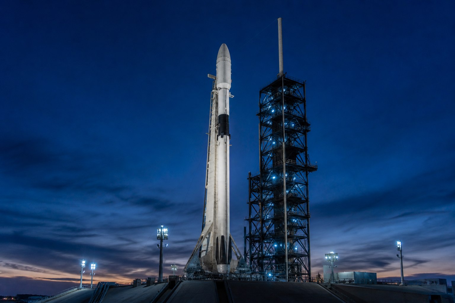 Orbital rocket standing on a launch pad at blue hour